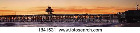 Stock Image - San Clemente Municipal Pier In Sunset, Panorama; San Clemente City, Orange County, Southern California, Usa. Fotosearch
