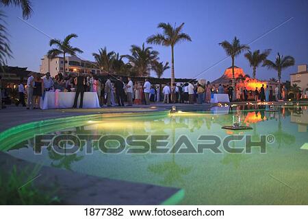 Stock Image - San Jose Del Cabo, Baja California, Mexico; Wedding Guests Celebrating Around The Pool At The Beach Club. Fotosearch