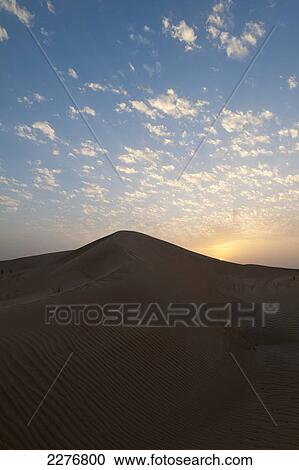 Stock Image - Sand dunes at dusk; Dubai, United Arab Emirates. Fotosearch