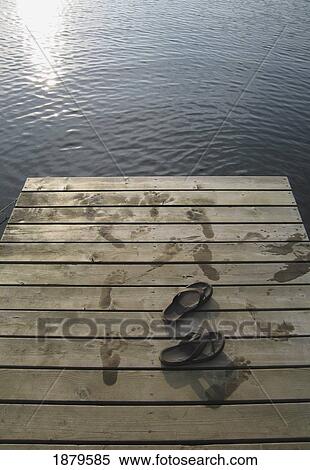 Stock Photography - Sandals On A Wooden Jetty By Lake. Fotosearch