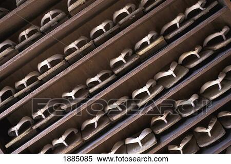 Stock Photography - Sandals On Shelves Outside Temple, Close Up. Fotosearch