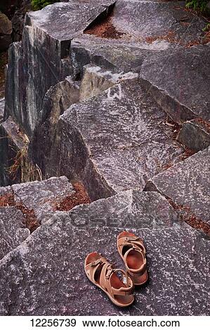 Sandals sitting on a rock ledge; Vancouver, British Columbia, Canada View Large Photo Image Stock Photo - Sandals sitting on a rock ledge; Vancouver, British Columbia, Canada. Fotosearch