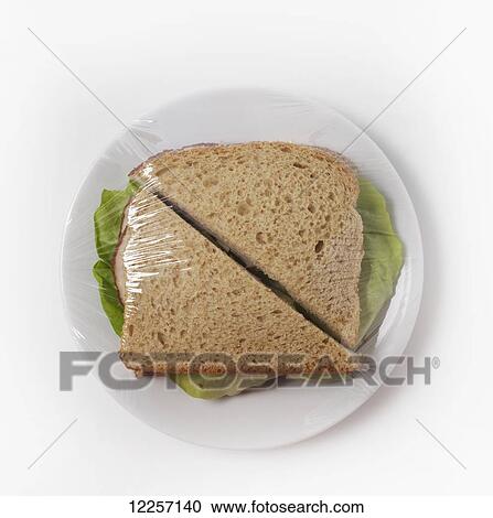Sandwich on a plate with plastic wrap View Large Photo Image Stock Image - Sandwich on a plate with plastic wrap. Fotosearch