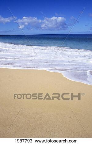 Stock Image - Sandy Tropical Beach, Turquoise Ocean, Seafoam, Blue Sky.. Fotosearch