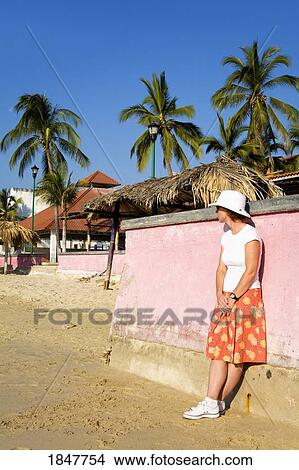 Santa Cruz Beach, Huatulco, Oaxaca State, Mexico; Woman Leaning On Wall On Beach View Large Photo Image Picture - Santa Cruz Beach, Huatulco, Oaxaca State, Mexico; Woman Leaning On Wall On Beach. Fotosearch