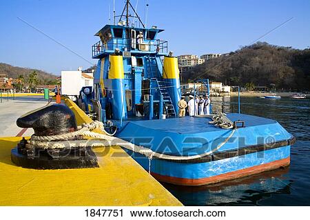 Stock Image - Santa Cruz Port, Huatulco, Oaxaca State, Mexico; Mexican Navy Tugboat Moored By Dock. Fotosearch