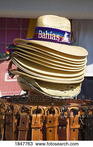 Stock Image - Santa Cruz Port, Huatulco, Oaxaca State, Mexico; Close Up Of Souvenir Hats And Belts In Handicraft Market. Fotosearch