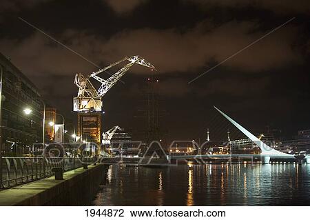 Santiago Calatrava's Puente de La Mujer (Women's Bridge) in Puerto Madero at night, Buenos Aires, Capital Federal, Argentina View Large Photo Image Stock Image - Santiago Calatrava's Puente de La Mujer (Women's Bridge) in Puerto Madero at night, Buenos Aires, Capital Federal, Argentina. Fotosearch