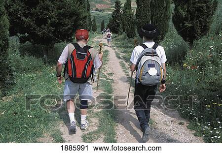 Stock Image - Santiago Pilgrims Walking From France, Passing Cirauqui Village. Fotosearch