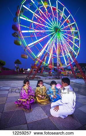 Saudi family enjoying amusement park; Tabuk, Saudi Arabia View Large Photo Image Stock Photo - Saudi family enjoying amusement park; Tabuk, Saudi Arabia. Fotosearch