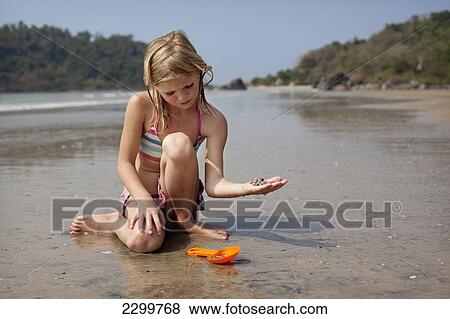 Savanna Rollason collects shells on Palolem beach, Goa, India. View Large Photo Image Stock Photo - Savanna Rollason collects shells on Palolem beach, Goa, India.. Fotosearch