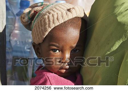 Scared Young Boy Gets Closer To His Mother In Ranohira, Fianarantsoa Province, Madagascar View Large Photo Image Stock Photograph - Scared Young Boy Gets Closer To His Mother In Ranohira, Fianarantsoa Province, Madagascar. Fotosearch