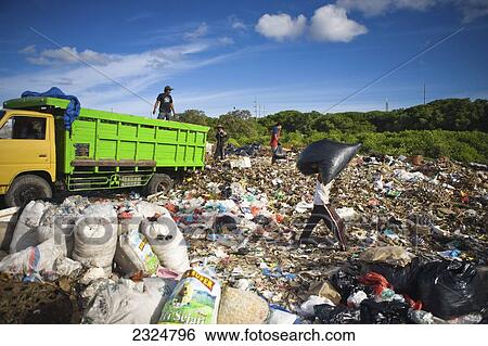 Stock Photograph - Scavenging In Unsanitary, Illegal Garbage Dump, Bali, Indonesia. Fotosearch