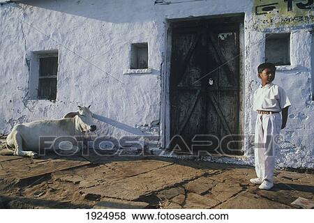 Stock Photo - Schoolboy Waits For His School Bus In Jhalawar. Fotosearch