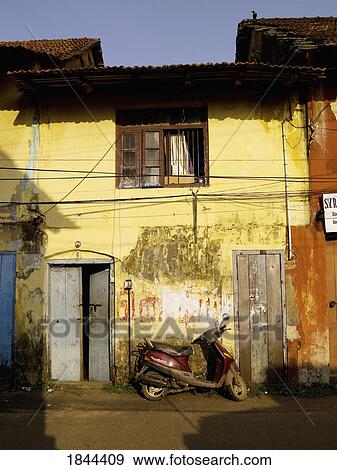 Stock Photo - Scooter Leaning Against Scraped House On Empty Street; Jewtown, Cochin, Kerala, India. Fotosearch