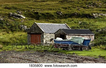 Stock Image - Scotland; Boat Docked By Boathouse. Fotosearch