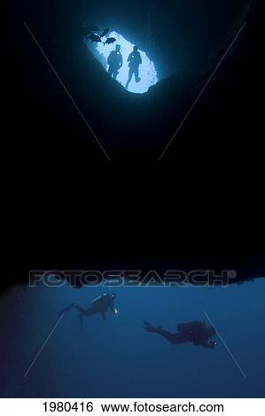 Stock Photograph - Scuba divers entering Blue Hole in Micronesia; Palua. Fotosearch
