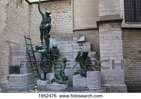 Stock Photograph - Sculpture depicting the workers outside Onze Lieve Vrouwekathedraal (Cathedral of our Lady), Antwerp, Belgium. Fotosearch