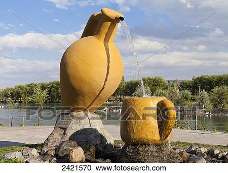 Sculpture of a clay pitcher pouring water into a cup; Avanos, Cappadocia, Turkey View Large Photo Image Stock Image - Sculpture of a clay pitcher pouring water into a cup; Avanos, Cappadocia, Turkey. Fotosearch