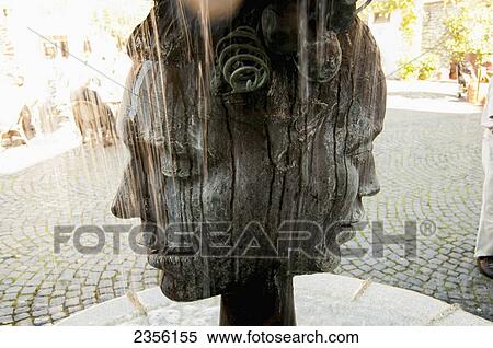 Stock Photography - Sculpture of a head with two faces; Bernkastel-Kues, Rhineland-Palatinate, Germany. Fotosearch