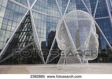 Sculpture of a human head in front of a modern building of windows; Calgary, Alberta, Canada View Large Photo Image Stock Photography - Sculpture of a human head in front of a modern building of windows; Calgary, Alberta, Canada. Fotosearch