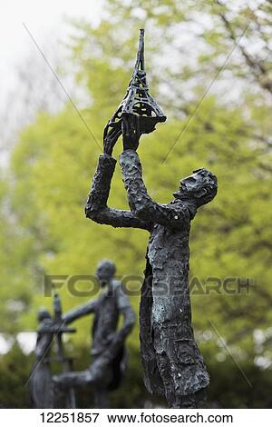 Sculpture of a man holding the Eiffel Tower; New York City, New York, United States of America View Large Photo Image Stock Photo - Sculpture of a man holding the Eiffel Tower; New York City, New York, United States of America. Fotosearch
