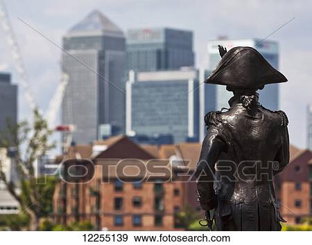 Sculpture of Admiral Lord Nelson in Greenwich with the buildings of Canary Wharf in the background; London, England View Large Photo Image Stock Photo - Sculpture of Admiral Lord Nelson in Greenwich with the buildings of Canary Wharf in the background; London, England. Fotosearch