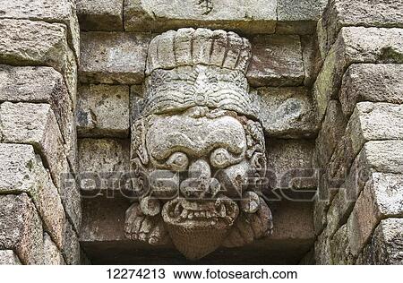 Stock Image - Sculpture on the Paduraksa (roofed-gate) to the first terrace of the 15th-century Javanese-Hindu temple, Candi Sukuh, Central Java, Indonesia. Fotosearch