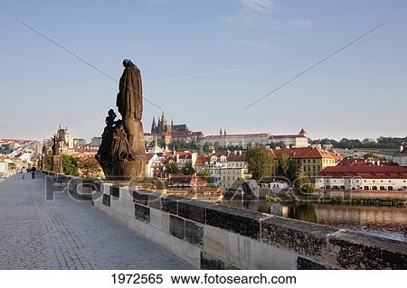 Stock Photography - Sculptures On The Charles Bridge With The Prague Castle In The Background At Sunrise, Prague, Czech Republic. Fotosearch