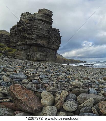 Stock Image - Sea stacks and colourful rocks along the coast of Iceland in the West Fjords; Iceland. Fotosearch