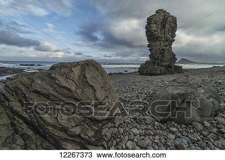 Stock Image - Sea stacks rise above the shoreline along the Strandir Coast in the West Fjords; Iceland. Fotosearch