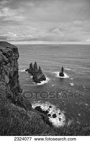 Sea stacks seen from a high sea cliff; Vik, Iceland View Large Photo Image Stock Photo - Sea stacks seen from a high sea cliff; Vik, Iceland. Fotosearch