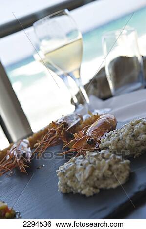 Stock Photograph - Seafood lunch at Restaurant Marinella. Located on the seafront at L'iIle Rousse. La Balagne. Corsica. France. Fotosearch