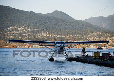 Stock Image - Seaplane Moored To Pier, Vancouver Waterfront, Harbor; Vancouver, British Columbia, Canada. Fotosearch