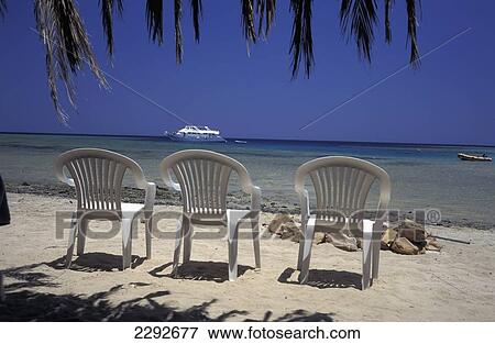 Stock Photo - Seascape With Chairs On Beach. Fotosearch