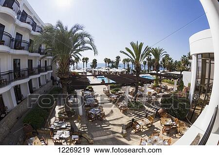 Seating on a patio with palm trees and a view of the mediterranean; Paphos, Cyprus View Large Photo Image Stock Photo - Seating on a patio with palm trees and a view of the mediterranean; Paphos, Cyprus. Fotosearch