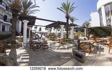 Seating on a patio with palm trees; Paphos, Cyprus View Large Photo Image Stock Photo - Seating on a patio with palm trees; Paphos, Cyprus. Fotosearch