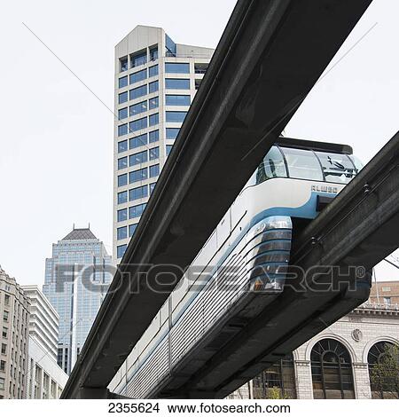 Picture - Seattle Centre Monorail Traveling On Track Overhead; Seattle, Washington, United States Of America. Fotosearch