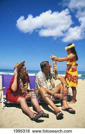 Senior Caucasian Tourist Couple Getting Lei From Young Girl On Beach View Large Photo Image Stock Photo - Senior Caucasian Tourist Couple Getting Lei From Young Girl On Beach. Fotosearch