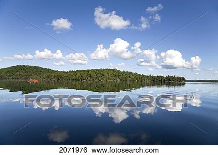 Stock Photograph - Senior Couple Canoeing On Smoke Lake, Algonquin Park, Ontario. Fotosearch