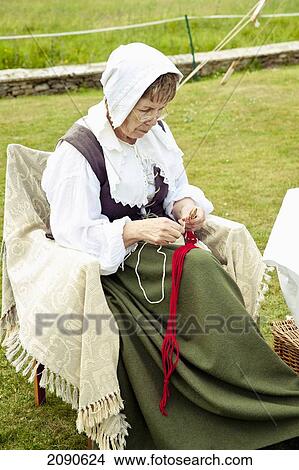 Senior Female Weaving While Sitting On Chair In Front Of Lacock Abbey, Lacock, Wiltshire, Uk View Large Photo Image Picture - Senior Female Weaving While Sitting On Chair In Front Of Lacock Abbey, Lacock, Wiltshire, Uk. Fotosearch