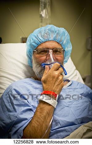 Stock Photo - Senior male in hospital bed prepped for surgery; Delta, British Columbia, Canada. Fotosearch