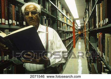 Senior Man In Library Reading Book View Large Photo Image Stock Photograph - Senior Man In Library Reading Book. Fotosearch