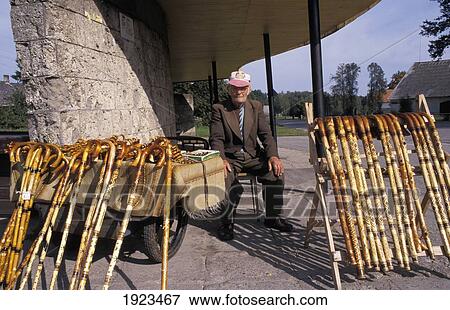 Stock Photo - Senior man selling walking sticks, Latvia. Fotosearch