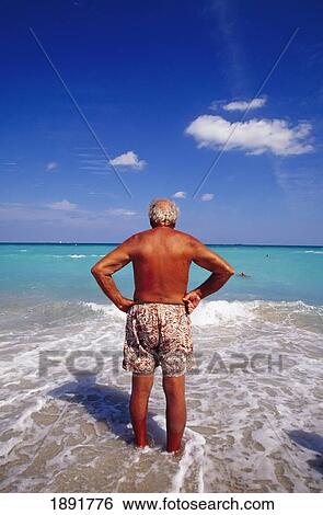 Senior Man Standing In Ocean, Rear View View Large Photo Image Stock Photograph - Senior Man Standing In Ocean, Rear View. Fotosearch
