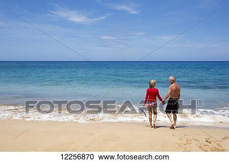 Senior tourists enjoying the turquoise water of Manele Bay at Hulupoe Beach, Manele Bay; Lanai, Hawaii, United States of America View Large Photo Image Stock Image - Senior tourists enjoying the turquoise water of Manele Bay at Hulupoe Beach, Manele Bay; Lanai, Hawaii, United States of America. Fotosearch