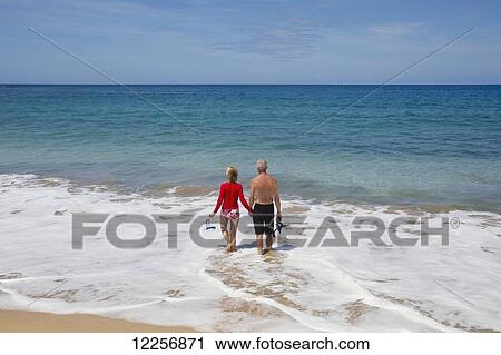 Senior tourists enjoying the turquoise water of Manele Bay at Hulupoe Beach, Manele Bay; Lanai, Hawaii, United States of America View Large Photo Image Stock Image - Senior tourists enjoying the turquoise water of Manele Bay at Hulupoe Beach, Manele Bay; Lanai, Hawaii, United States of America. Fotosearch
