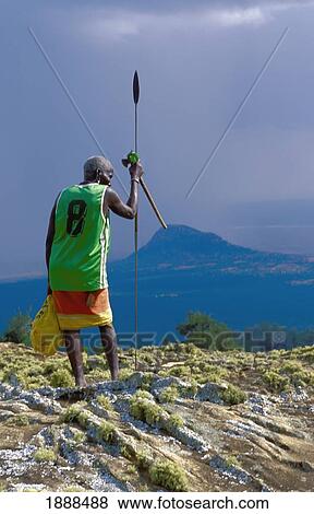 Stock Photo - Senior Tribesman Wearing A Modern Basketball Shirt With His Traditional Dress. Fotosearch