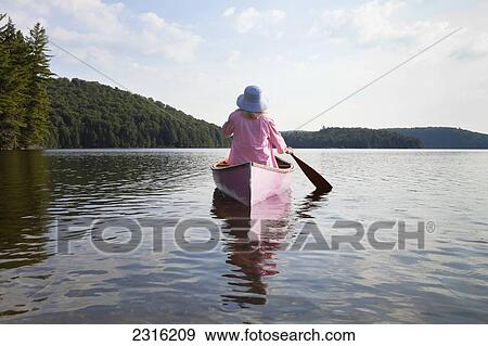 Senior Woman Dressed In Pink And Paddling Her Pink Canoe On Lake In Algonquin Park; Ontario Canada View Large Photo Image Stock Photo - Senior Woman Dressed In Pink And Paddling Her Pink Canoe On Lake In Algonquin Park; Ontario Canada. Fotosearch