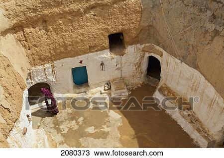 Senior Woman Lives In An Underground Cave House In The Tataouine Province; Matmata, Tunisia, North Africa View Large Photo Image Stock Image - Senior Woman Lives In An Underground Cave House In The Tataouine Province; Matmata, Tunisia, North Africa. Fotosearch